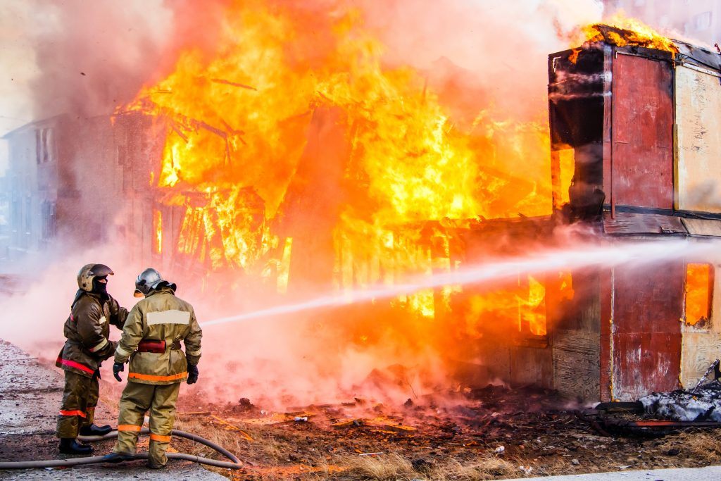 Novyy Urengoy, Russia - May 14, 2015: Old wooden residential house burns with black smoke and heavy flames.